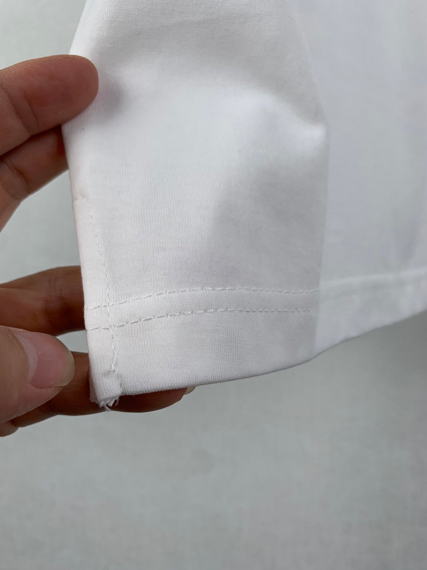 White T-shirt lower hem with double-stitched edge