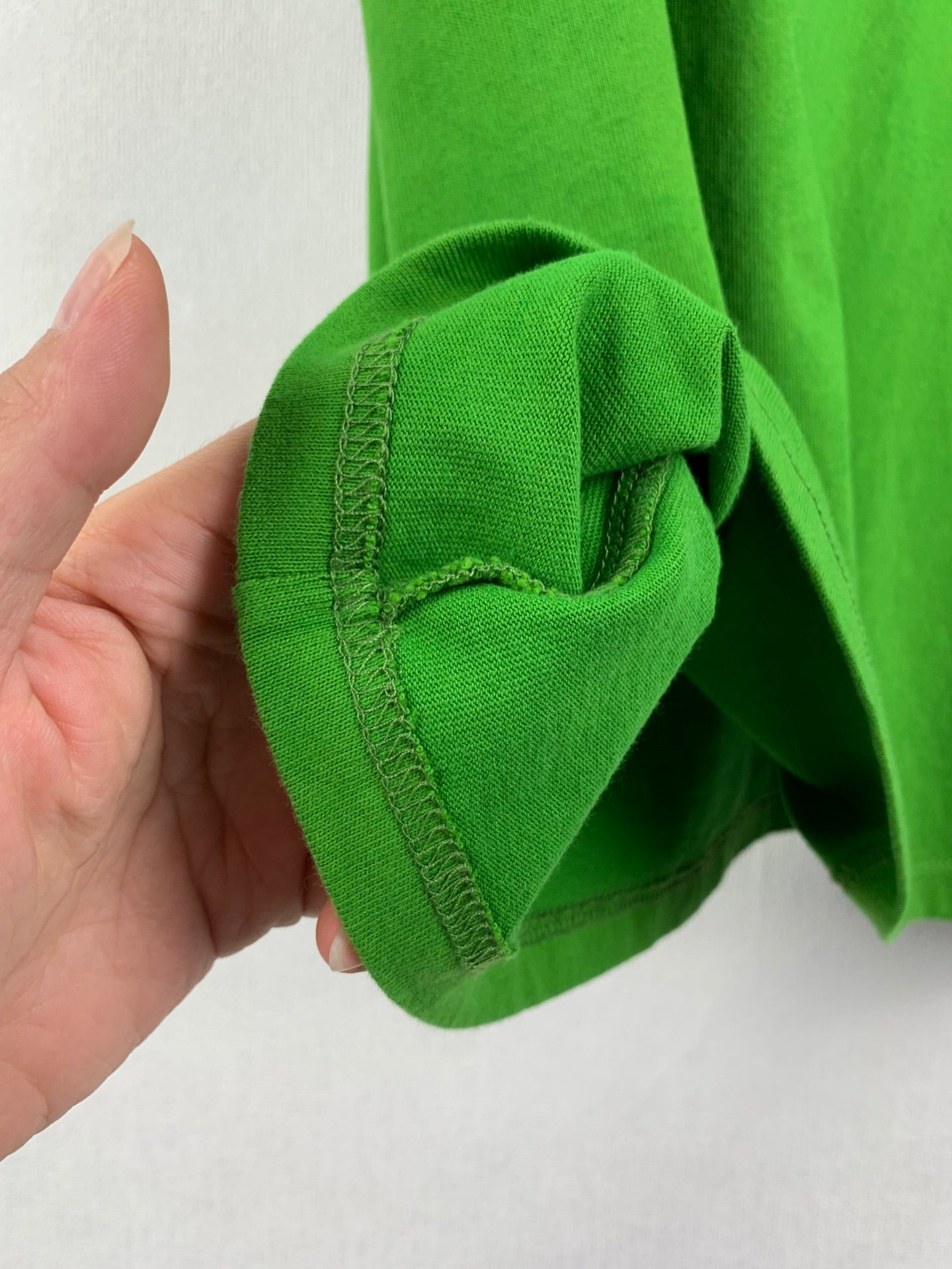 Prada short-sleeve T-shirt in bright green, sleeve cuff seam close-up