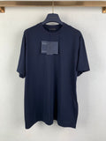 Navy Prada crewneck T-shirt on hanger with front hang tags
