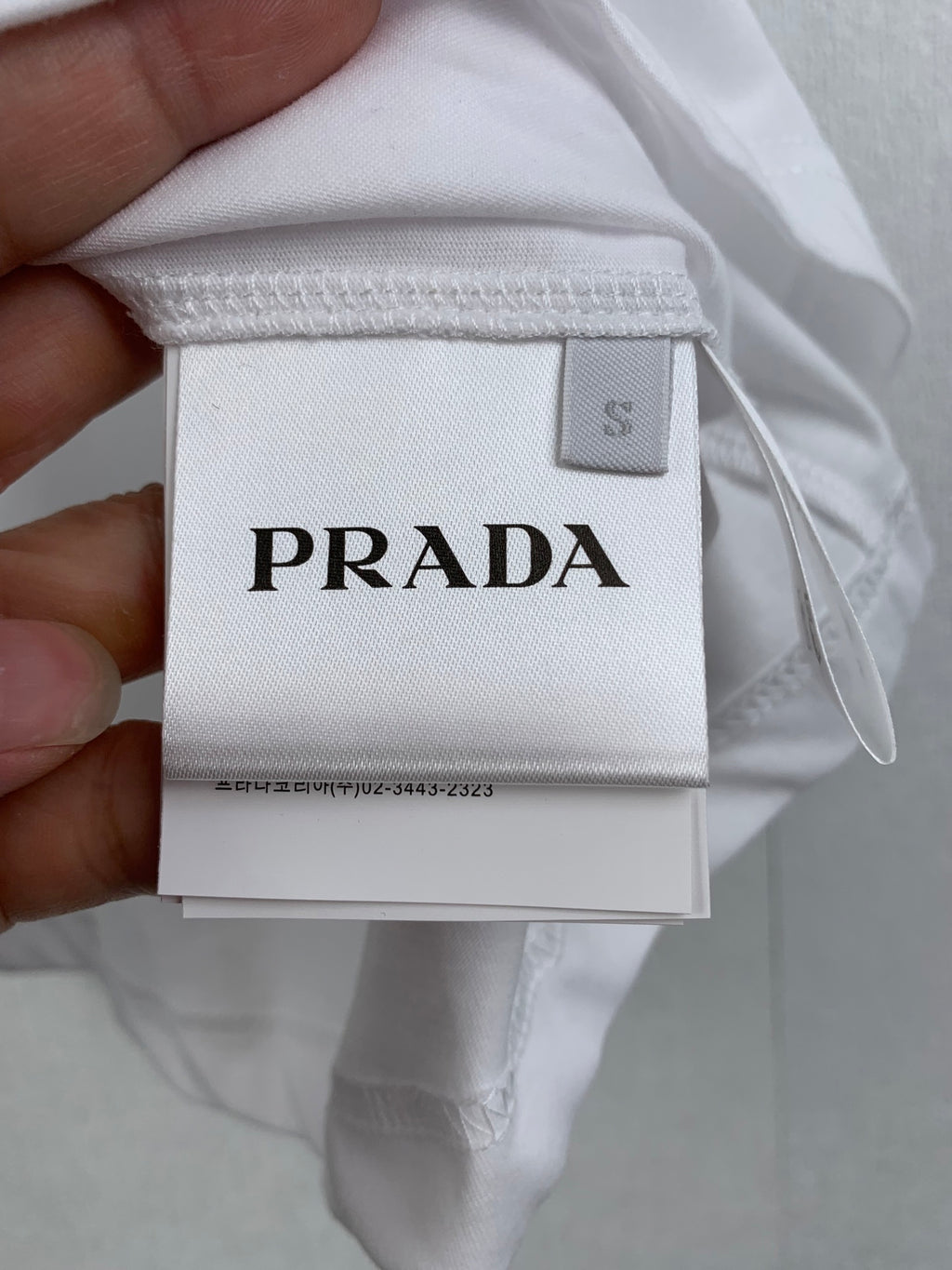 White T-shirt size label marked PRADA
