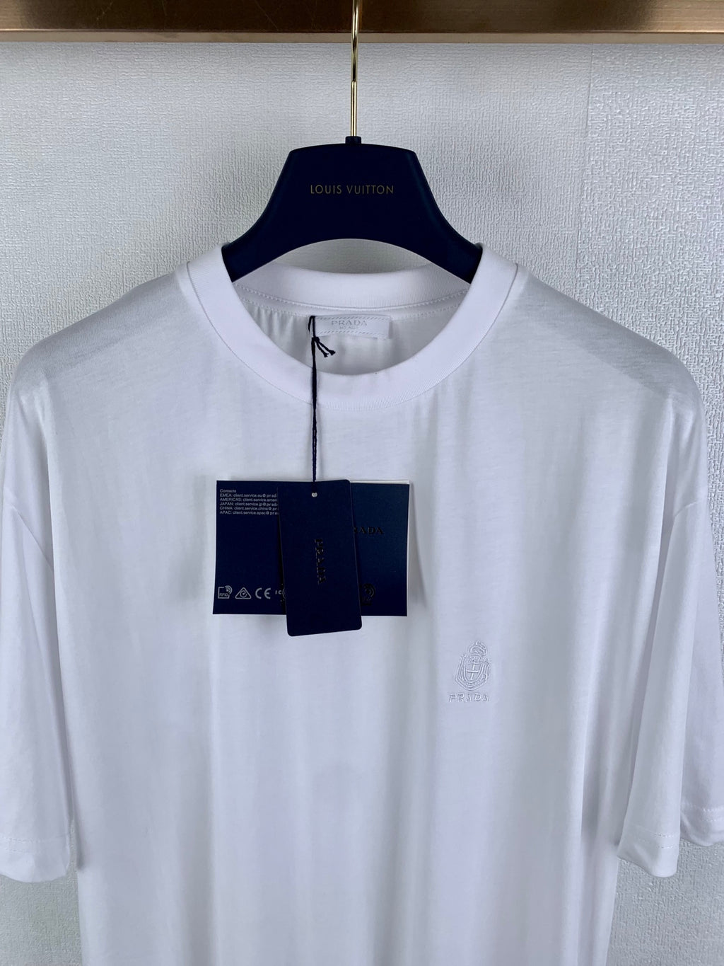 White crew-neck short-sleeve T-shirt with subtle chest embroidery