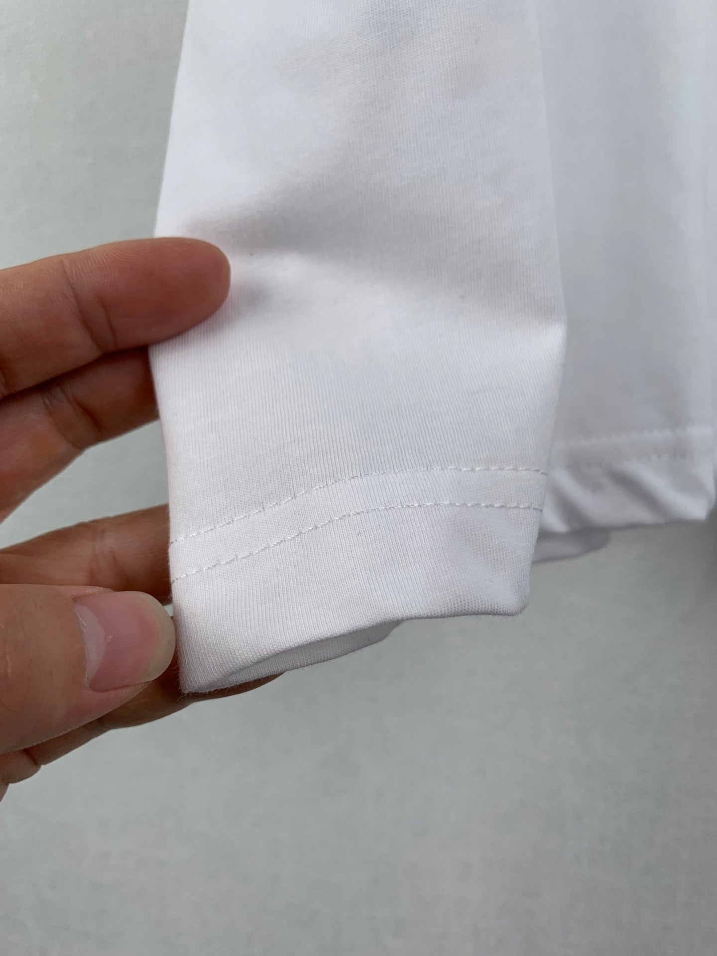 White T-shirt sleeve cuff seam detail