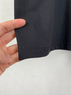 Prada T-shirt hem close-up in dark fabric with seam stitching
