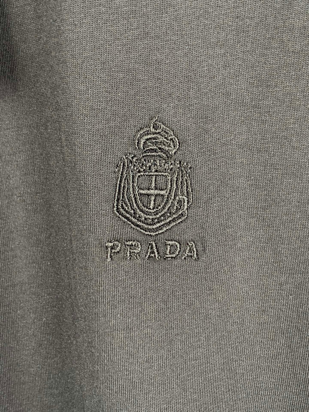 Prada T-shirt logo crest and PRADA text on dark fabric