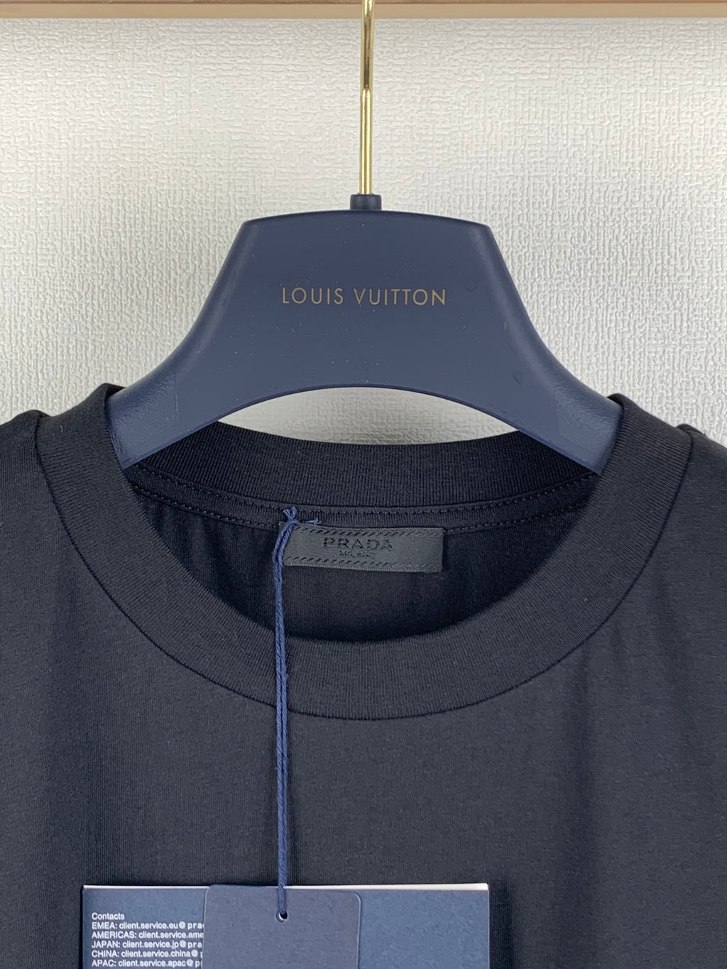 Prada crewneck T-shirt in dark fabric, collar and inner label close-up