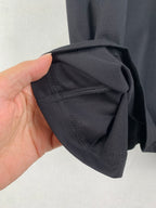 Prada T-shirt sleeve cuff close-up in dark fabric with stitching