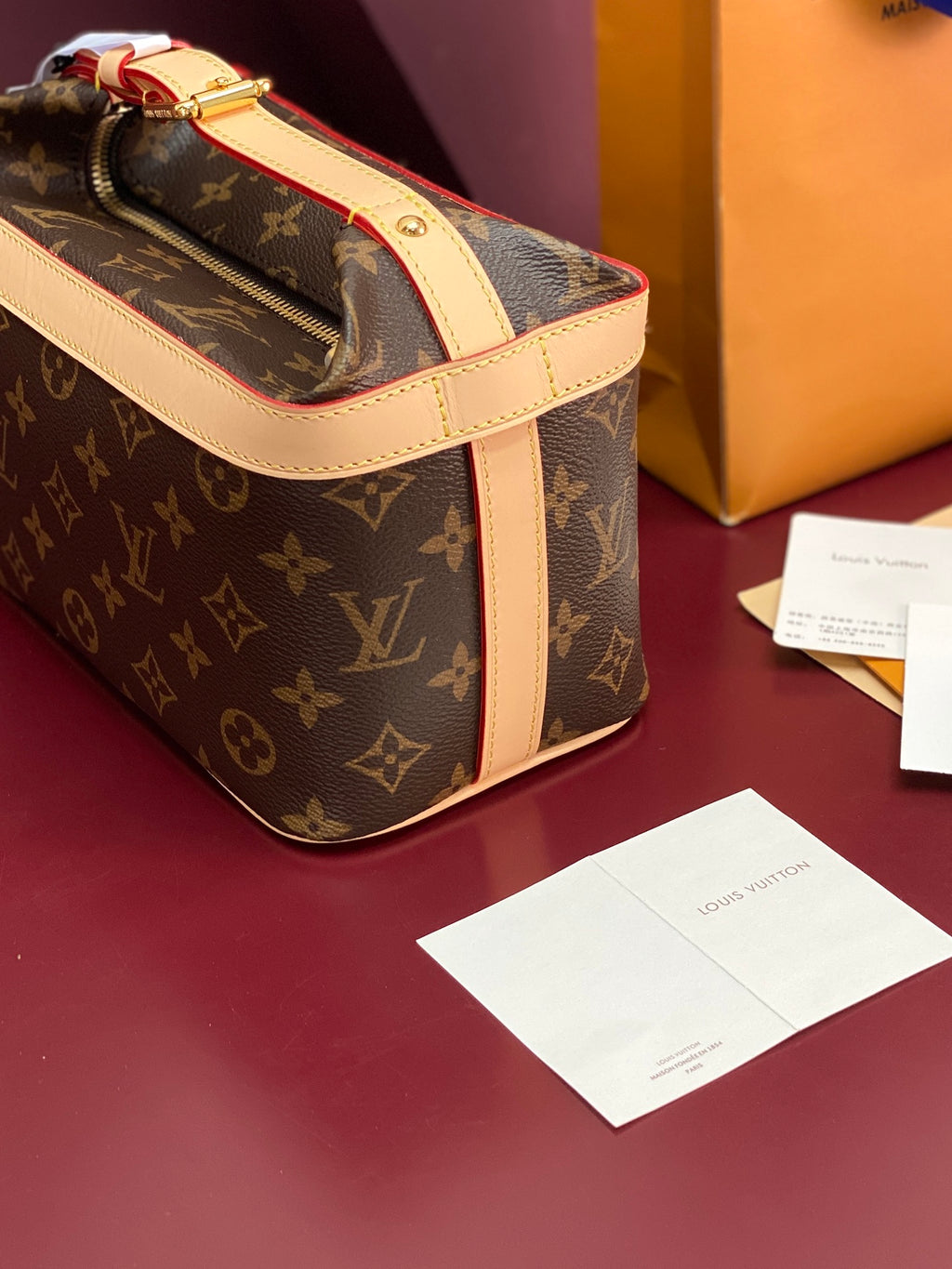 Louis Vuitton monogram bag side view with cream strap, gold zipper pull