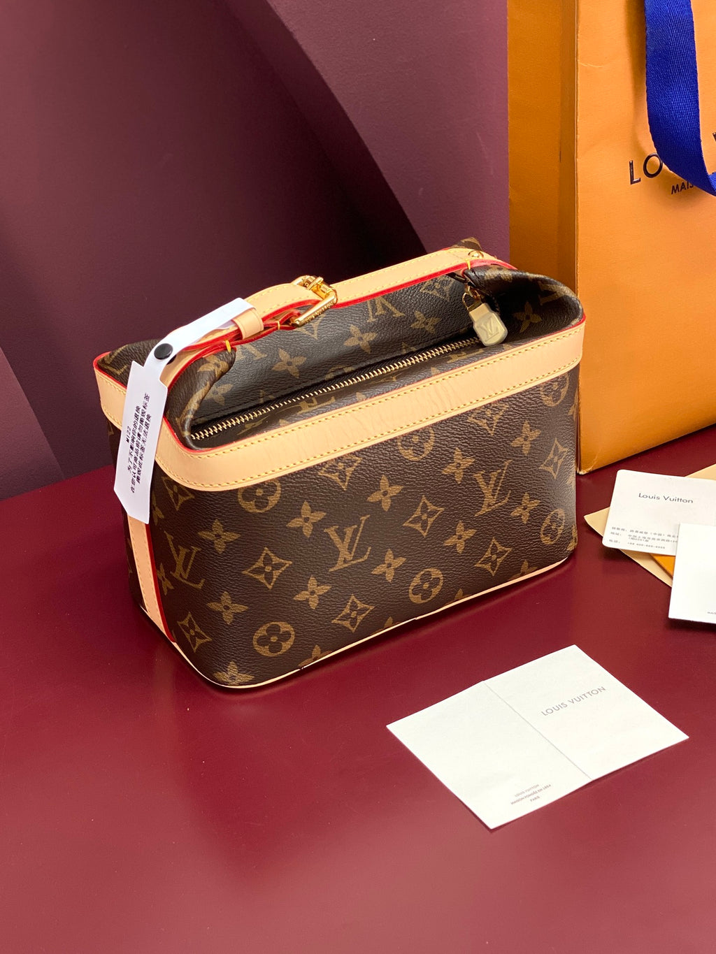 Louis Vuitton monogram bag in brown with cream trim, zip-top view