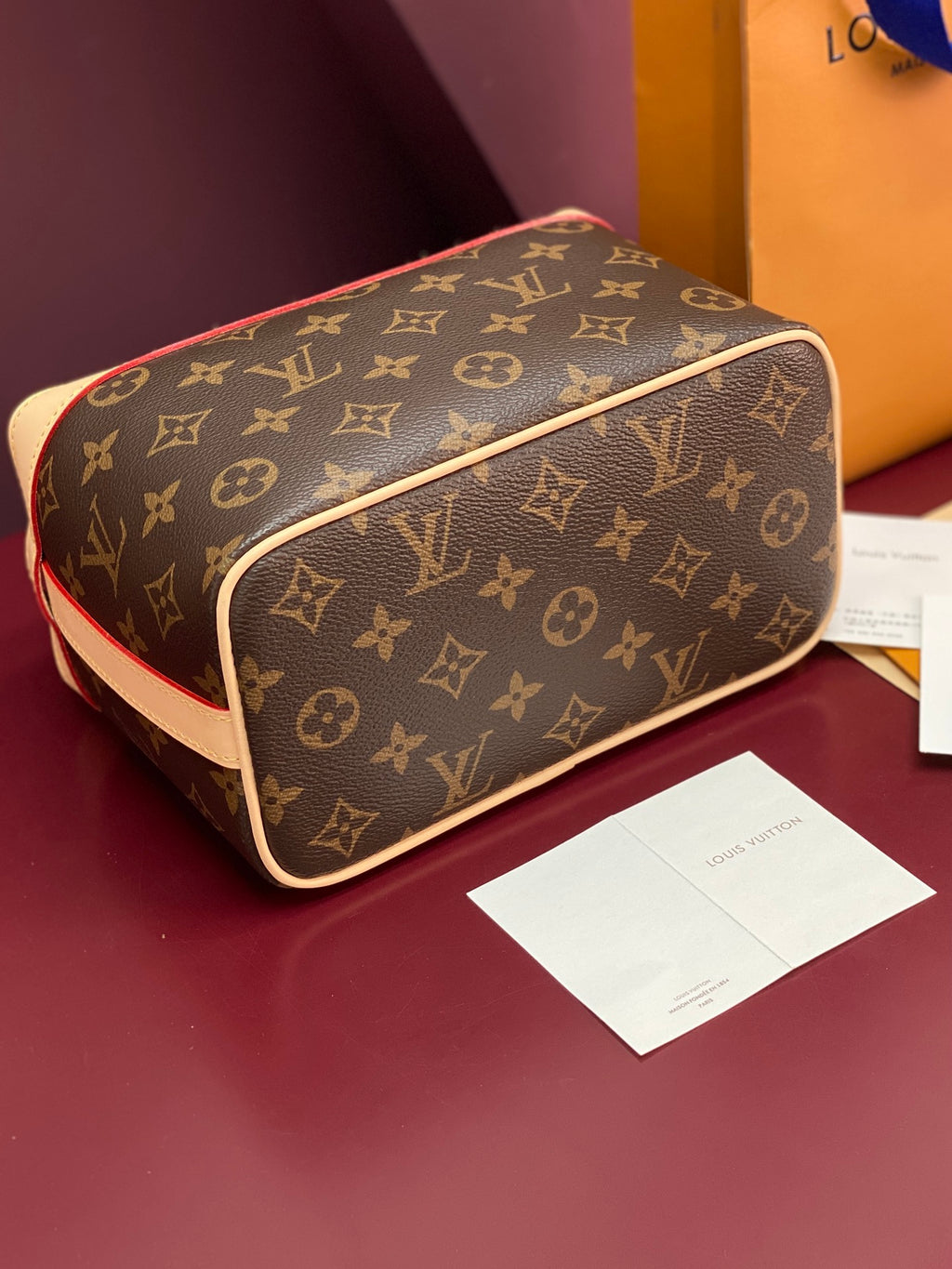 Louis Vuitton monogram bag top view with cream edge trim and gold zipper