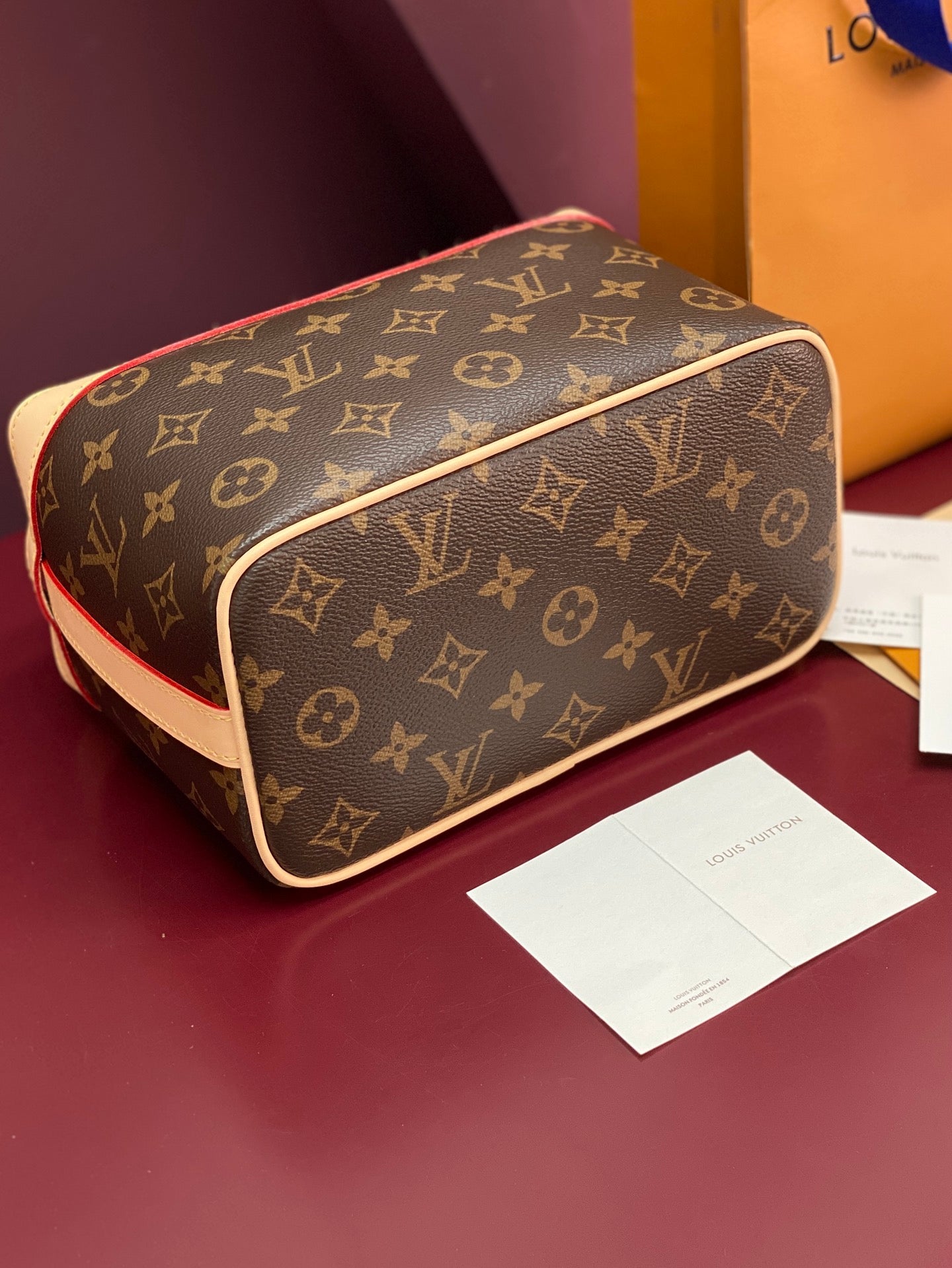 Louis Vuitton monogram bag top view with cream edge trim and gold zipper