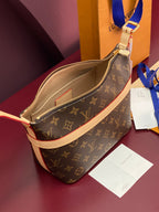 Louis Vuitton monogram bag with open zip and beige interior lining, cream trim