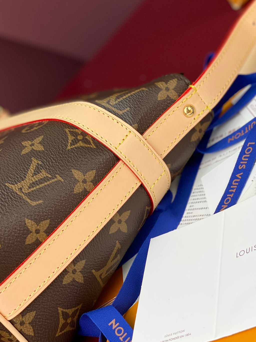 Louis Vuitton monogram bag with beige leather trim and adjustable strap