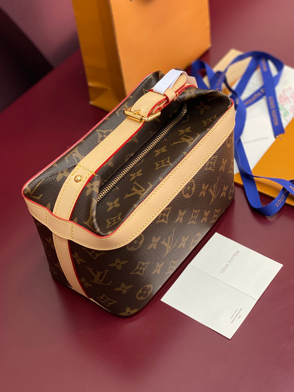 Louis Vuitton monogram bag with long strap, cream trim, gold zipper hardware