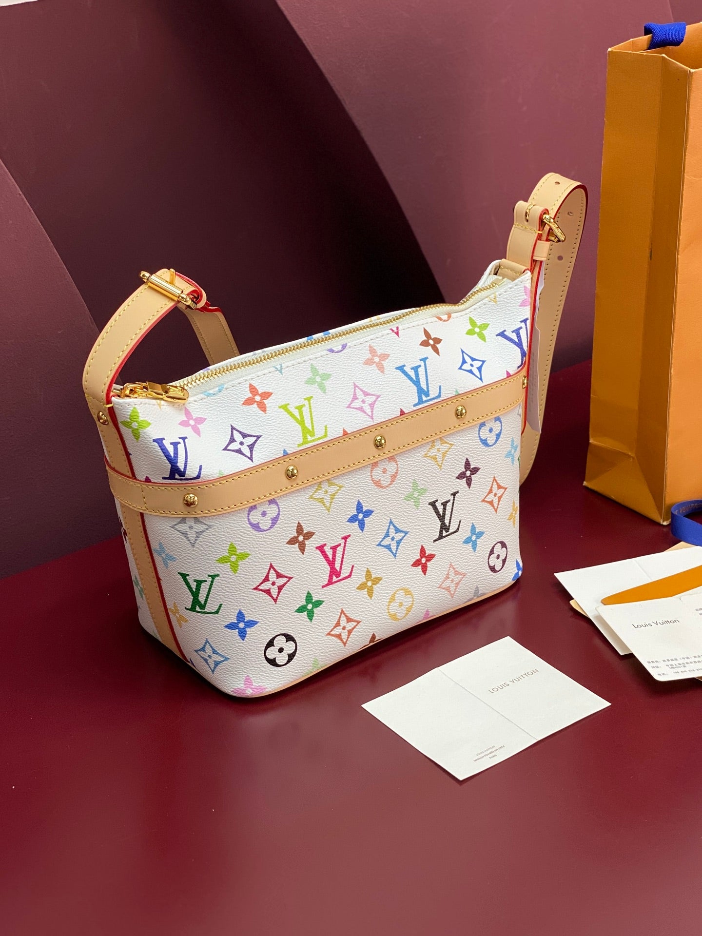 Louis Vuitton multicolor monogram hobo bag with tan shoulder strap and gold hardware