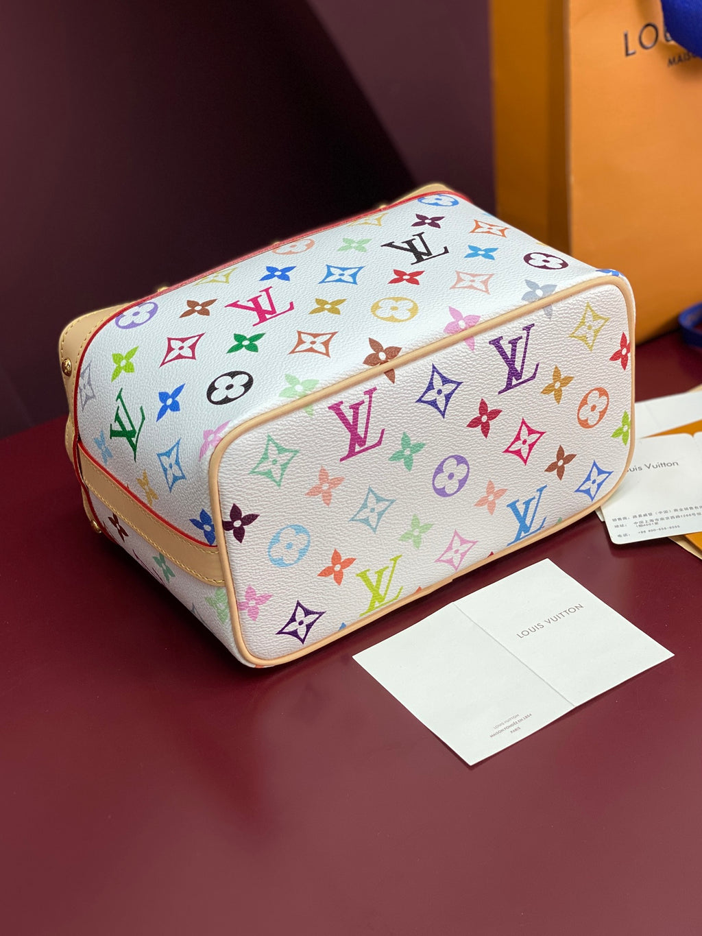 Louis Vuitton mini handbag top view with multicolor monogram pattern and tan trim