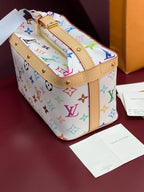 Louis Vuitton mini handbag with multicolor monogram print and tan top strap hardware