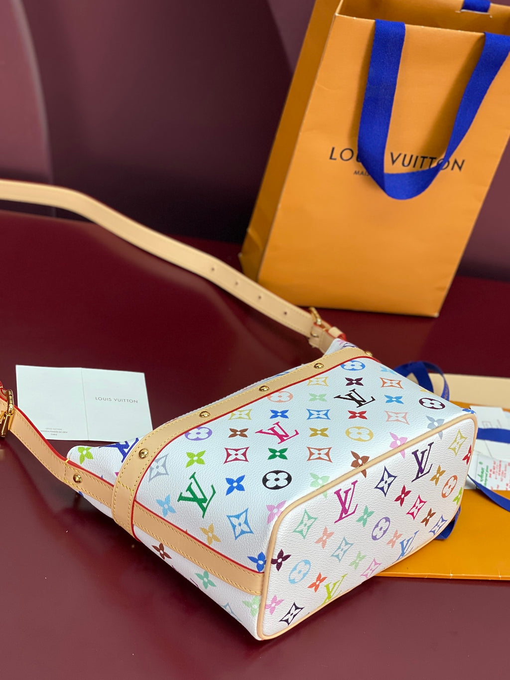 Louis Vuitton multicolor monogram crossbody bag with gold buckle and tan strap