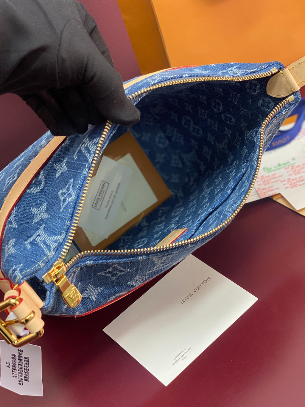 Louis Vuitton blue monogram bag interior with tan lining and gold zipper track