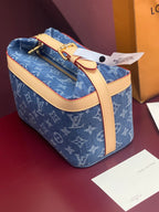 Louis Vuitton blue monogram bag with tan leather strap and gold top hardware