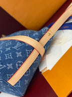 Louis Vuitton blue monogram bag with tan leather trim and top handle strap