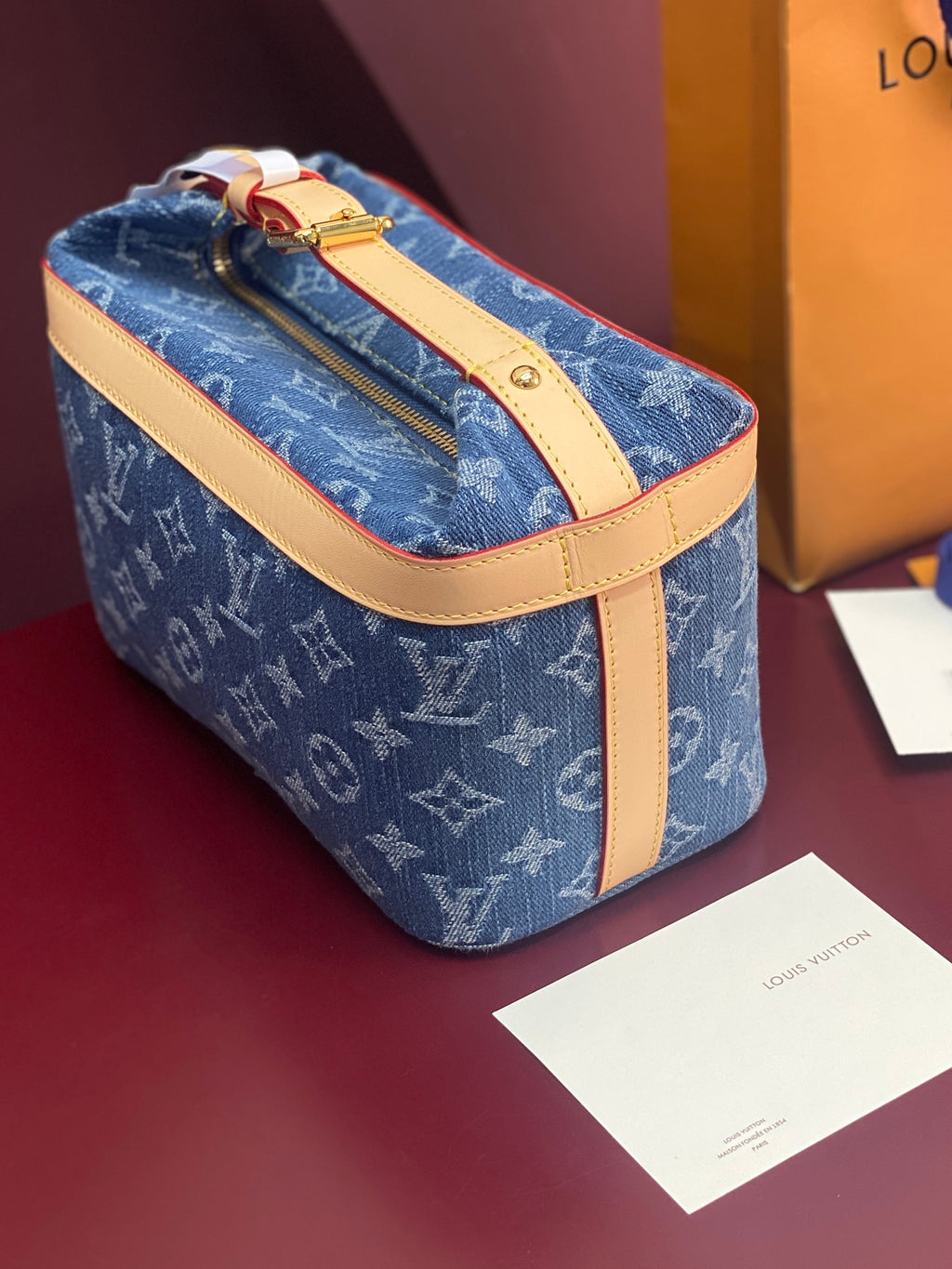 Louis Vuitton blue monogram bag with tan handle strap and gold top zipper
