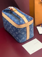Louis Vuitton blue monogram bag with tan handle strap and gold top zipper