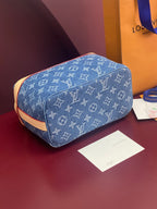Louis Vuitton blue monogram bag with rounded top and tan trim detail