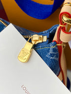 Louis Vuitton blue monogram bag lock charm with gold clasp and tan leather details