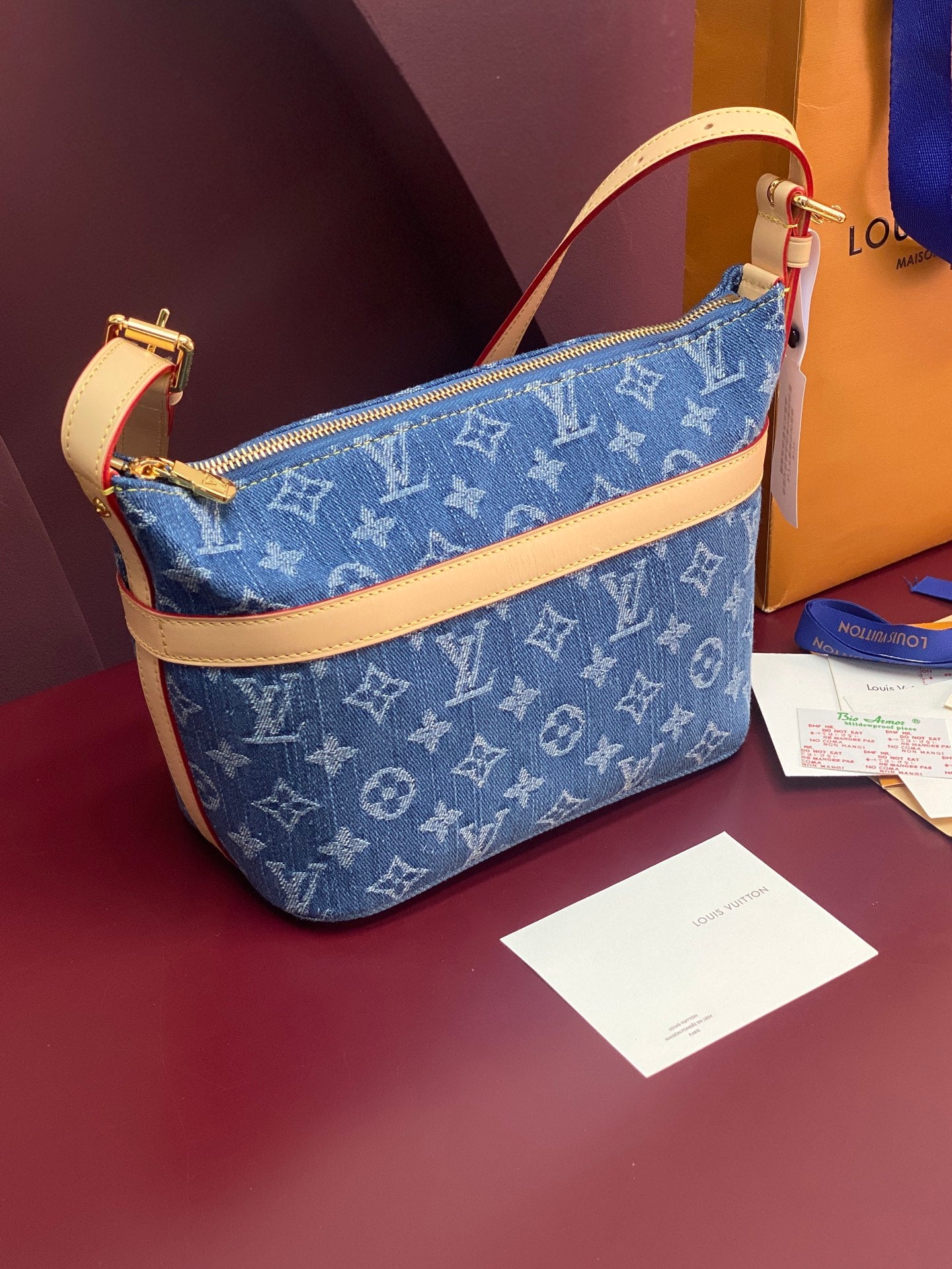 Louis Vuitton blue monogram shoulder bag with tan leather trim and gold hardware