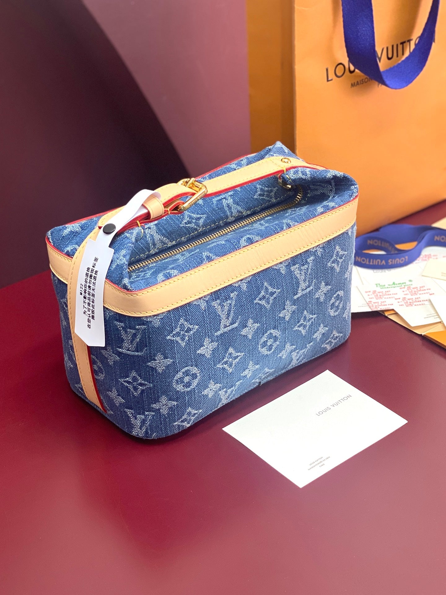 Louis Vuitton bag in blue monogram canvas with tan leather trim and top zipper