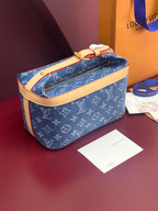 Louis Vuitton blue monogram bag with tan leather strap and gold top zip closure