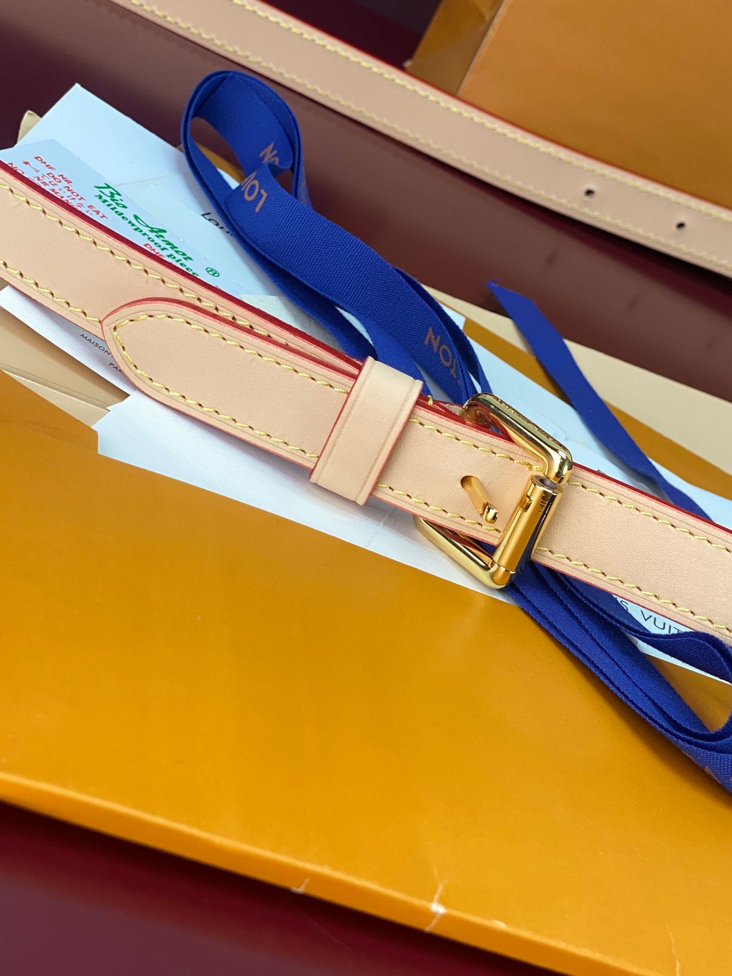 Louis Vuitton bag strap with tan leather and gold buckle hardware