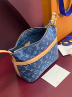Louis Vuitton blue monogram bag with open zipper top and tan leather trim