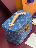Louis Vuitton blue monogram vanity bag with tan handle and gold zipper trim