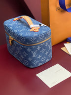 Louis Vuitton blue monogram mini vanity bag with top handle and front zipper pull