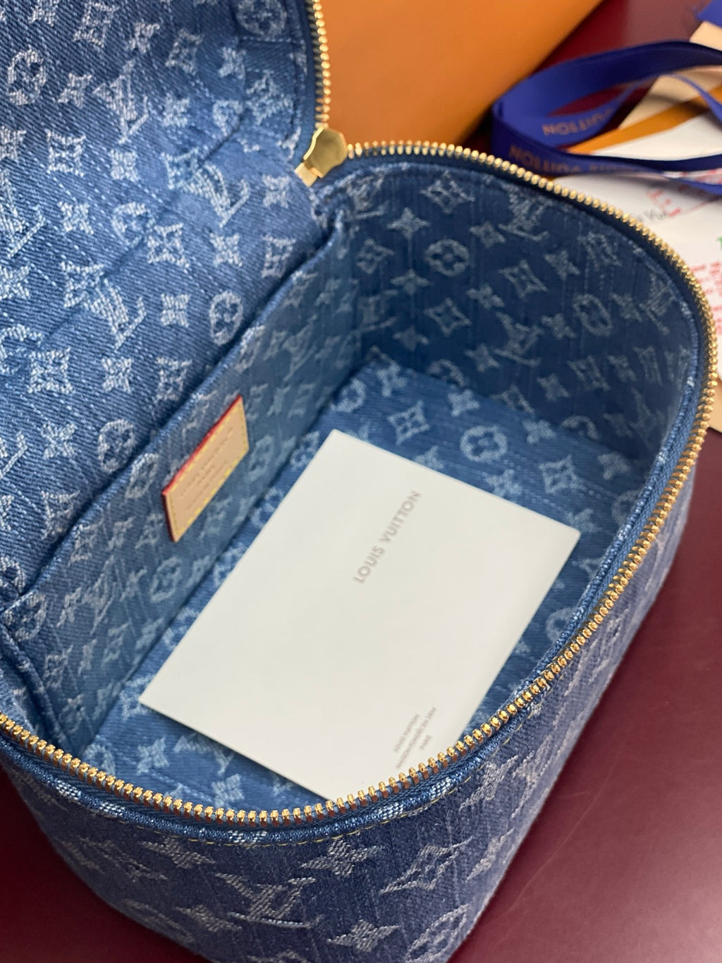 Louis Vuitton blue monogram vanity bag open, interior with white tag card