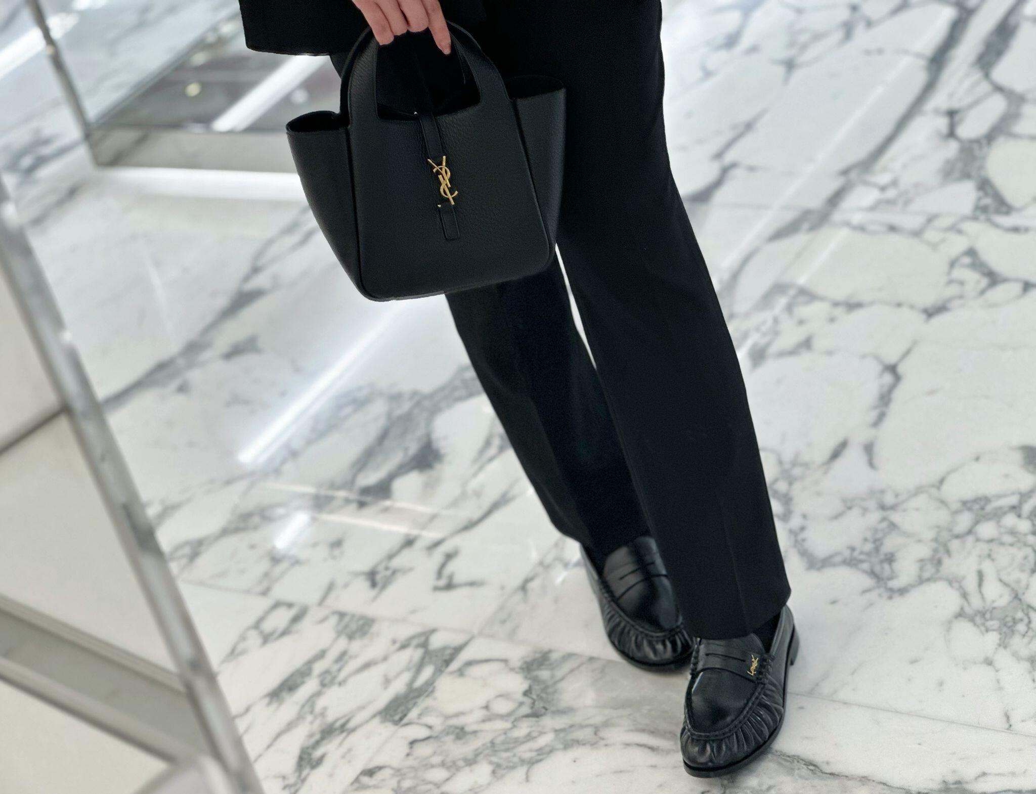 YSL leather tote bag in dark color with top handles and gold YSL logo detail