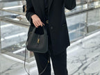 YSL leather crossbody-style tote bag in dark color with top handles and gold YSL logo