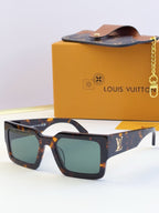 Louis Vuitton sunglasses with tortoiseshell frames and green-tinted lenses, LV logo on temple.