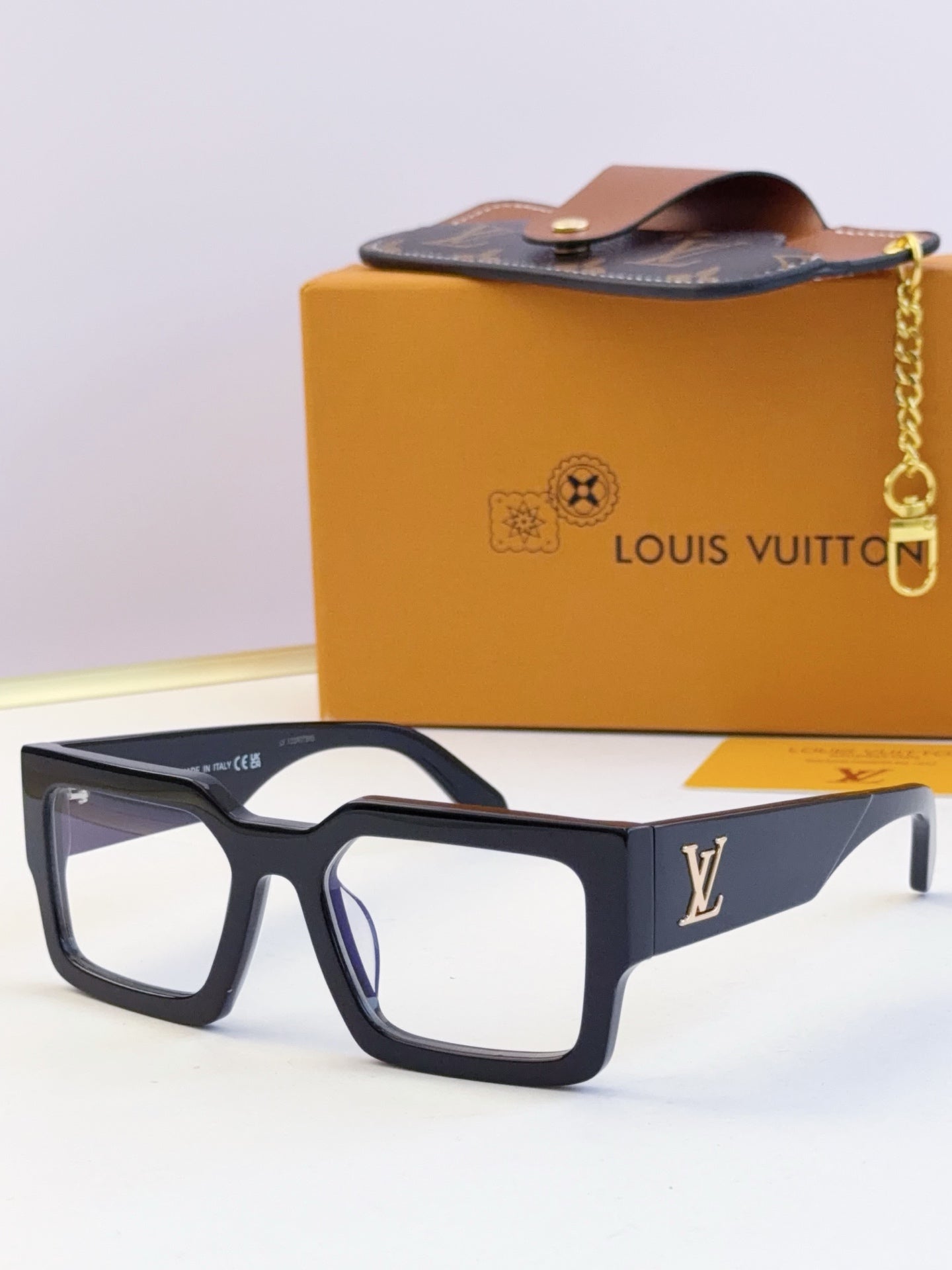 Louis Vuitton sunglasses with dark blue square frames and clear-lens style, LV logo on temple.