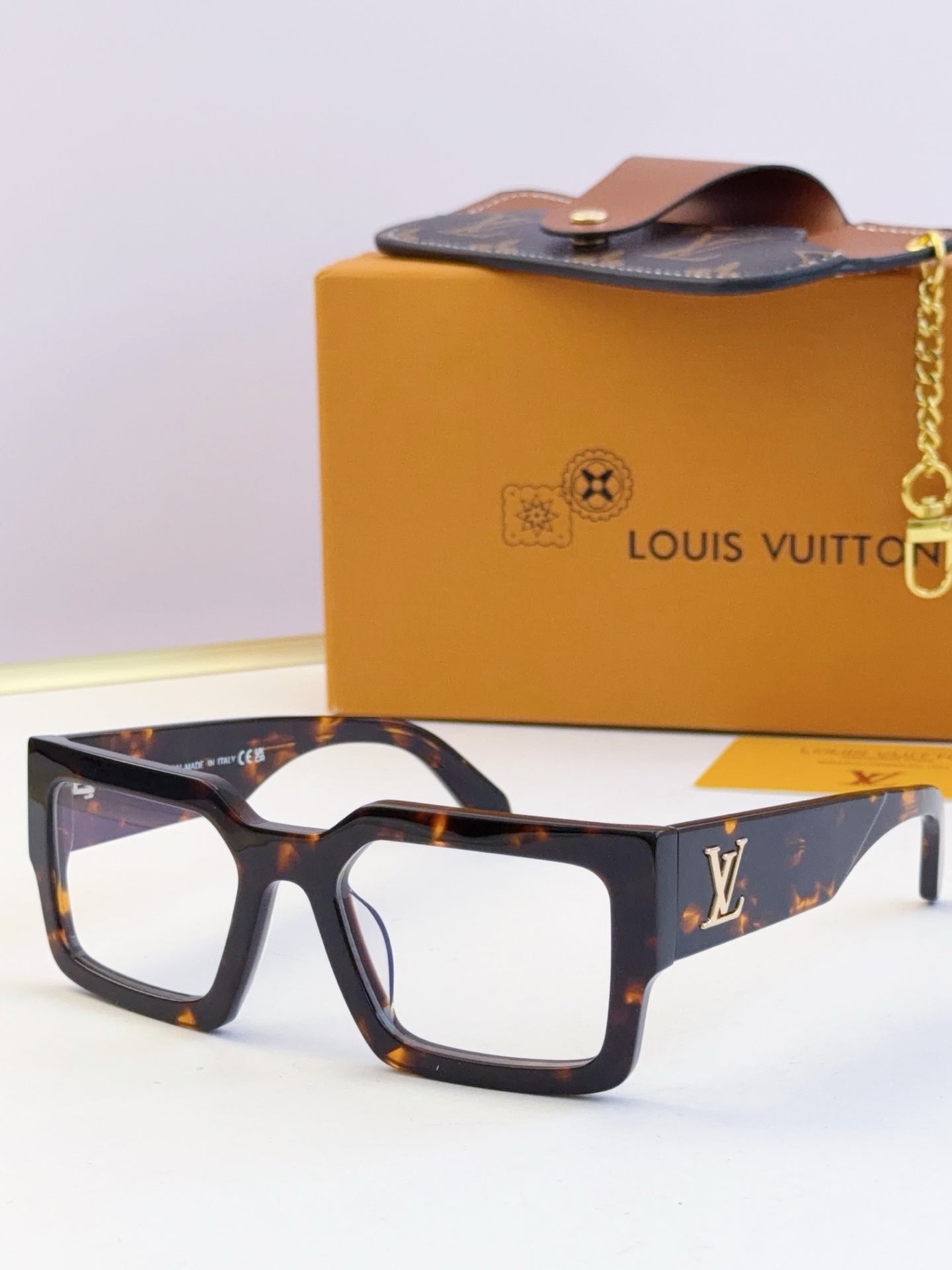 Louis Vuitton sunglasses with tortoiseshell square frames and dark tinted lenses, LV logo.