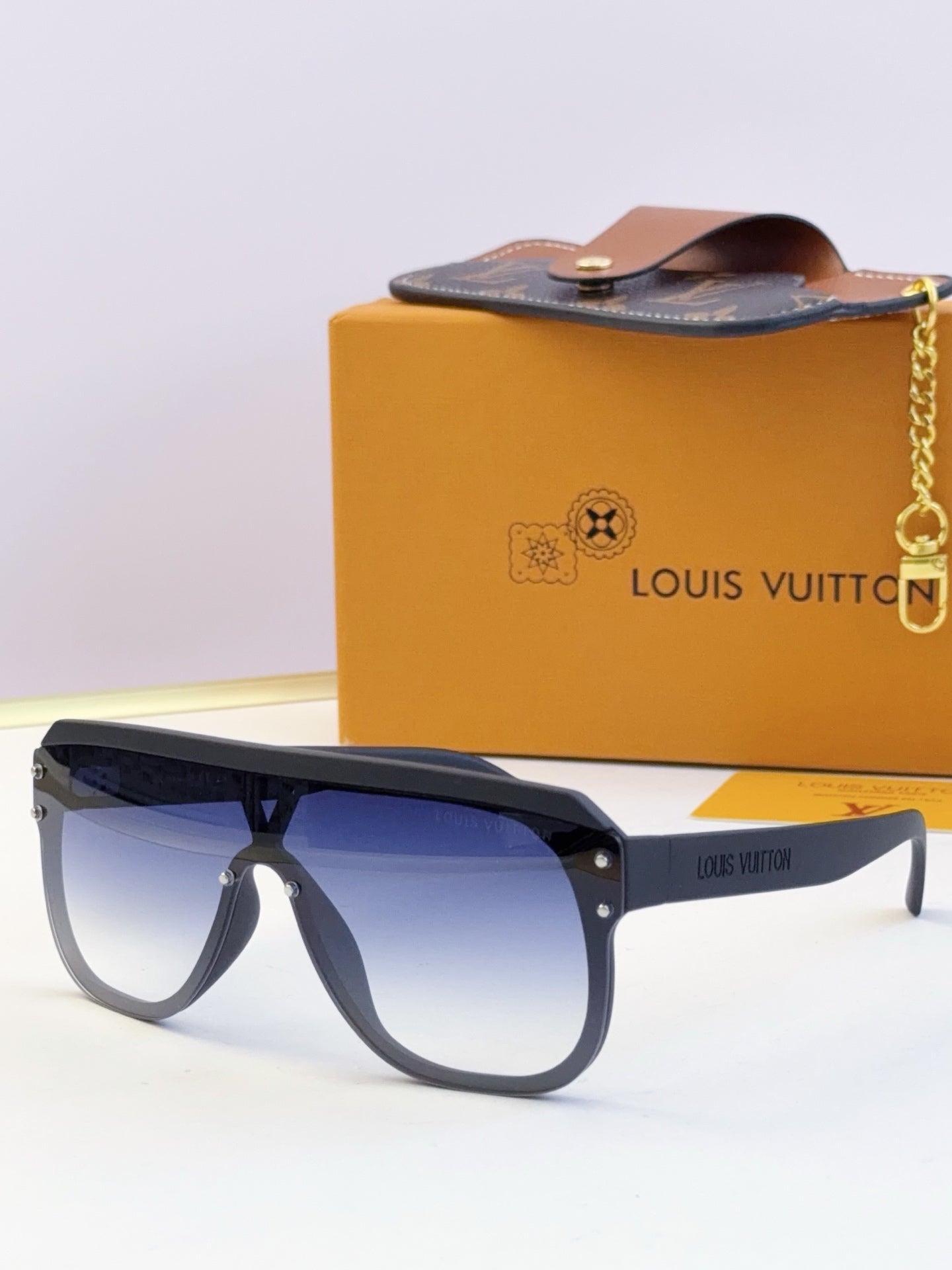 Navy sunglasses with blue tinted lenses and logo text on the temple