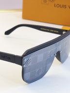 Side view of blue patterned sunglasses with dark arms and tinted lens