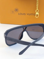 Blue sunglasses with purple tinted lenses and logo text on the temple