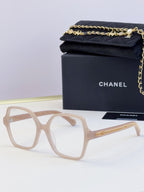 Chanel light beige square glasses with clear lenses and gold chain detail on arms