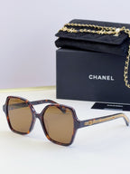 Chanel tortoiseshell square sunglasses with amber lenses and gold chain on arms