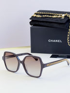 Chanel gray-blue square glasses with tinted lenses and gold chain detail