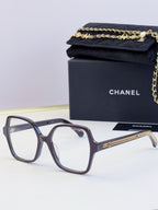 Chanel dark navy square glasses with clear lenses and gold chain on arms