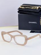 Light tan glasses with oversized square frames and clear lenses