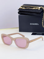 Light tan glasses with oversized square frames and pink tinted lenses